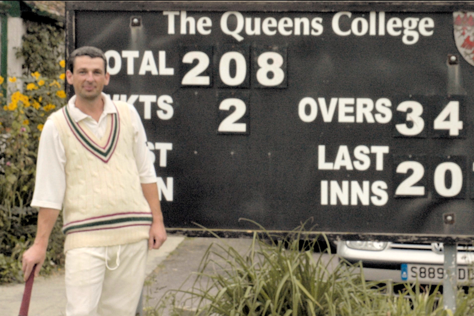 Rich Stephenson in front of the Queen's scoreboard